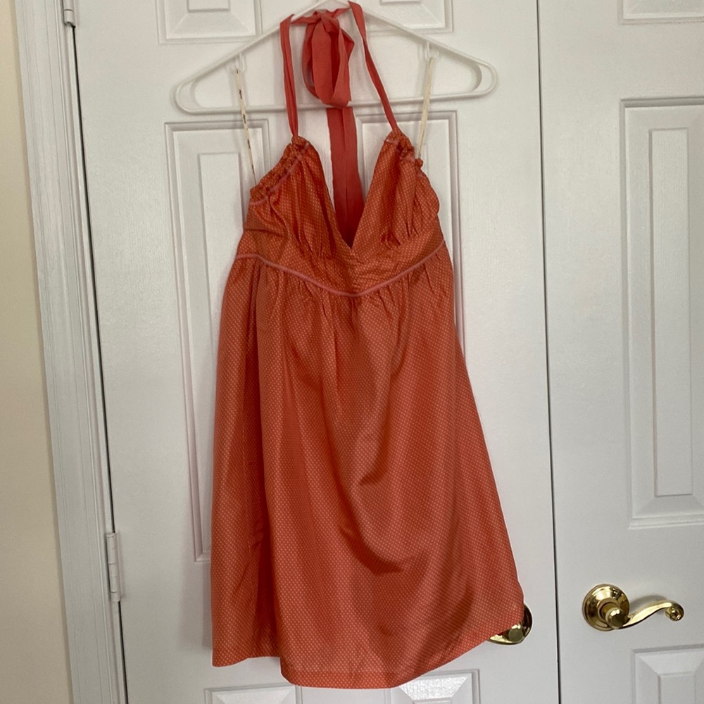 Orange and white polka dot mini halter dress.